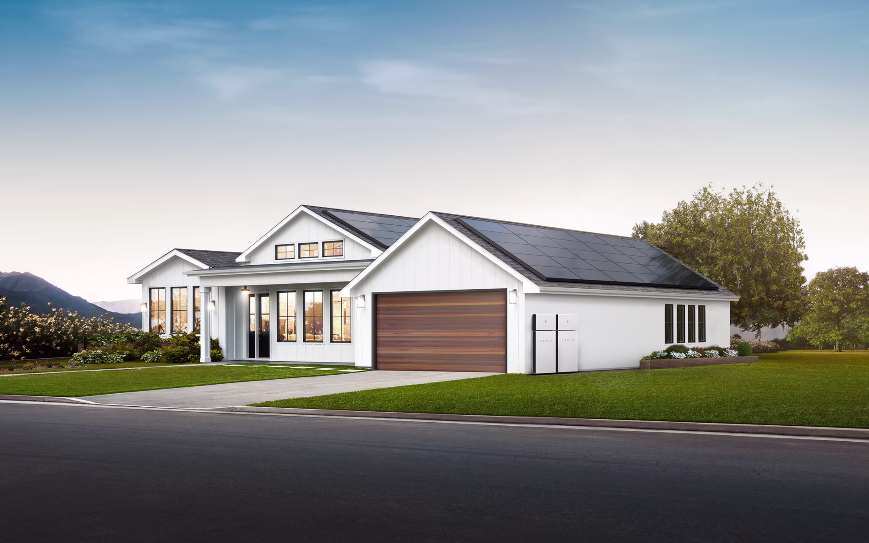 Modern home with Tesla solar panels on roof at sunset